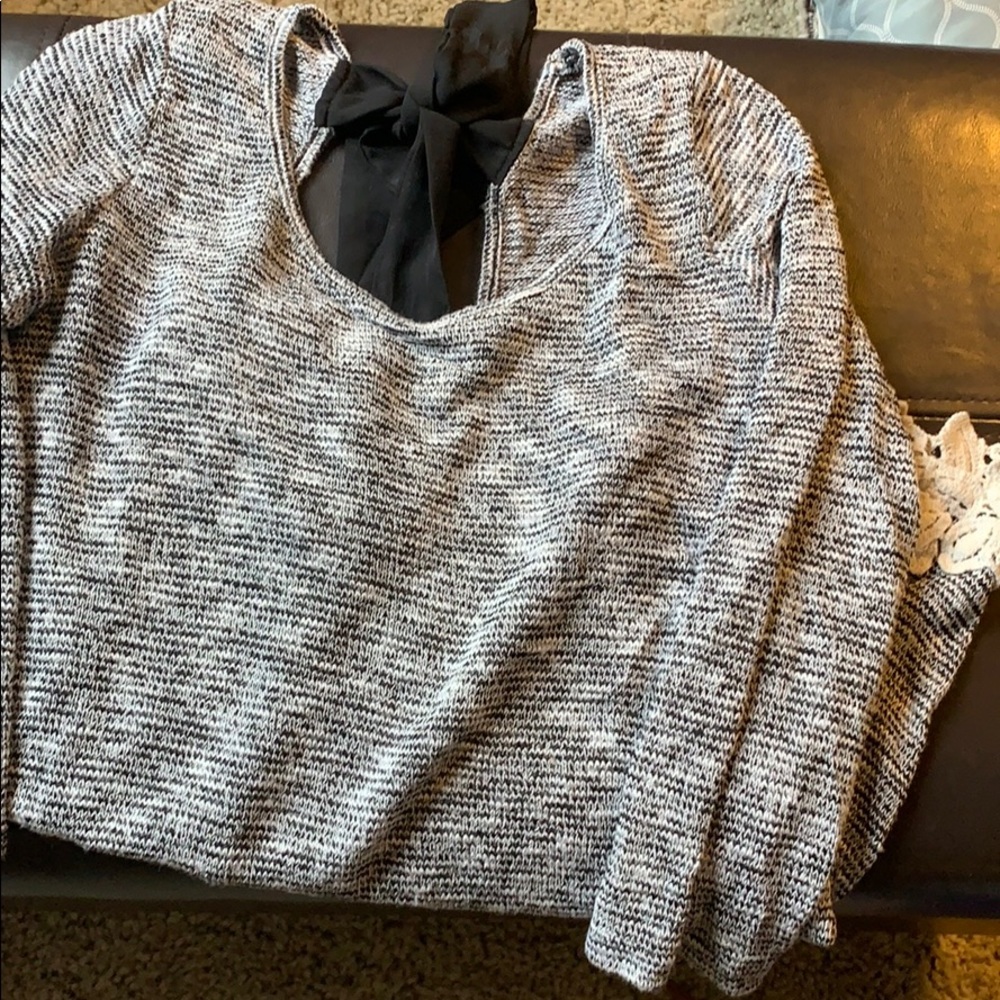 Adorable black and white sweater with tie back bow